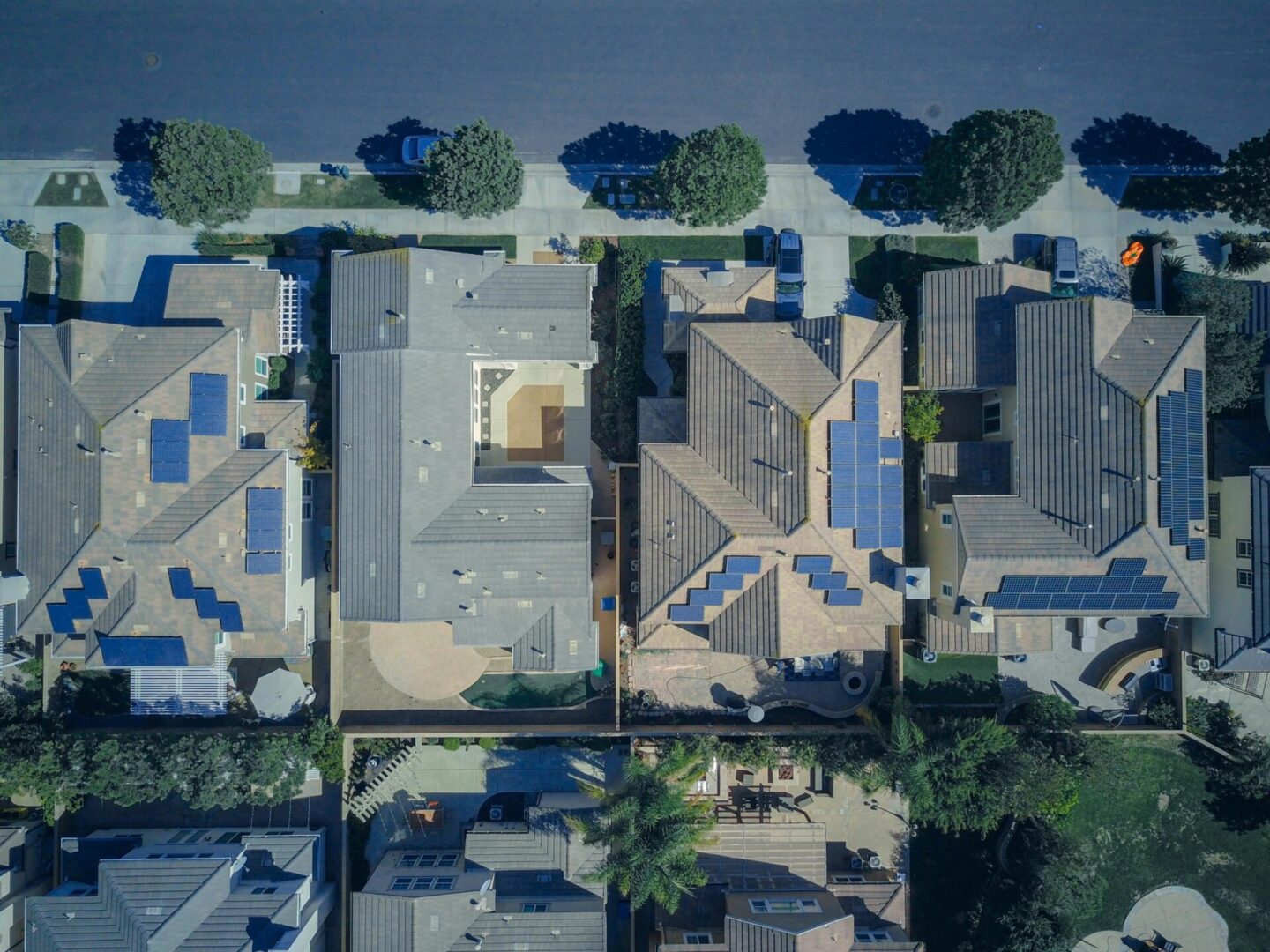 A bird 's eye view of houses with solar panels on them.